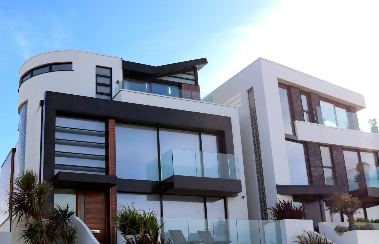who-we-are Contemporary luxury home with glass balconies in Poole, UK, showcasing modern architectural design.